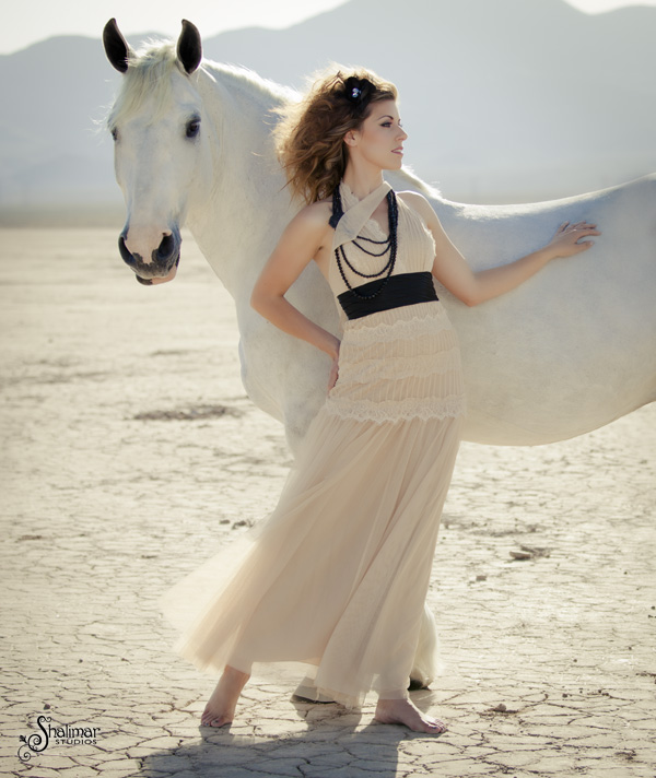 a woman with a horse in the beach